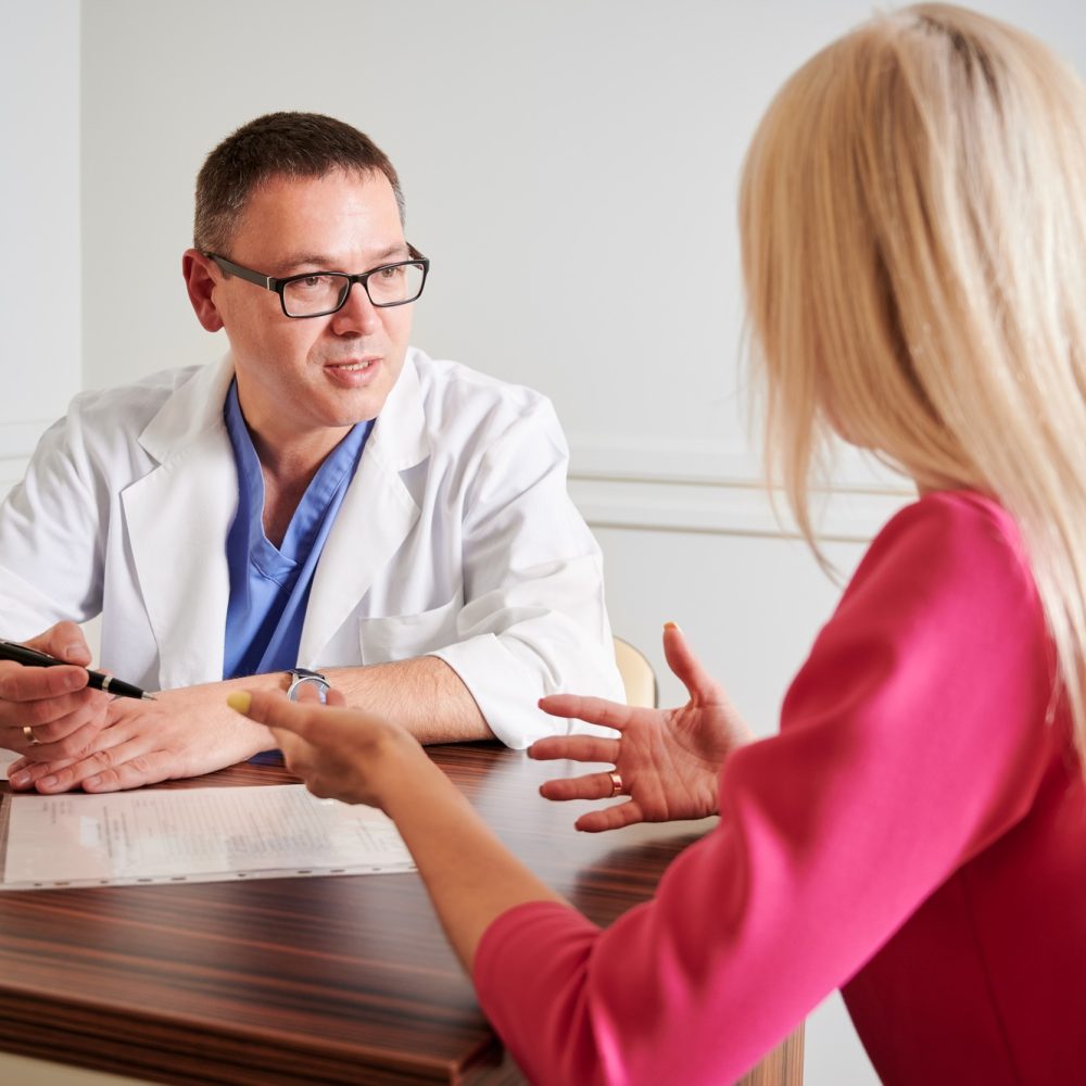 Female patient having consultation with doctor in clinic.